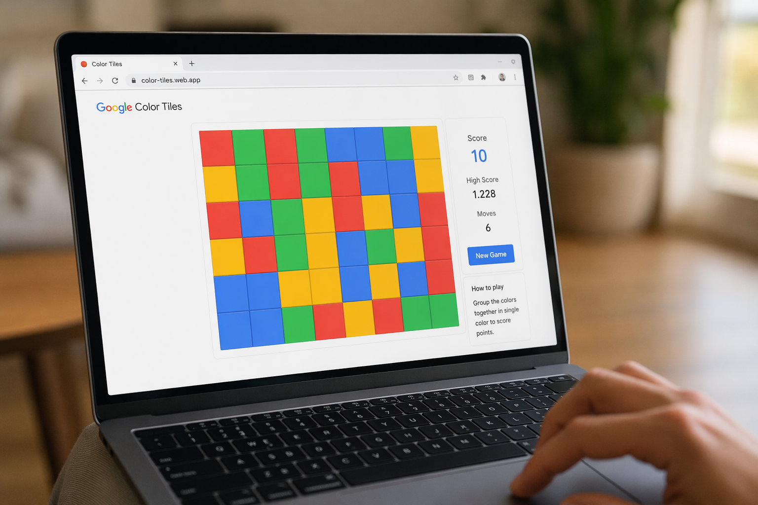 A close-up of a person playing the Google Color Tiles game on a laptop screen.